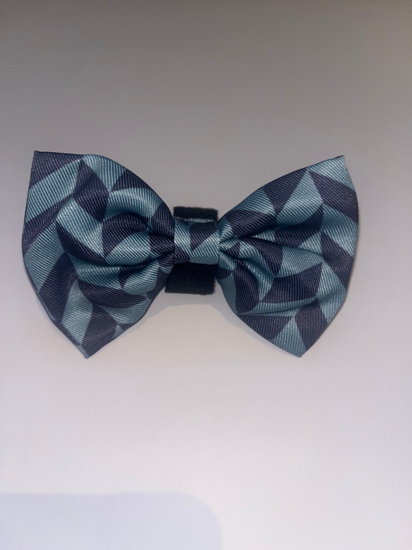 Blue geometric dog bow tie on a white background