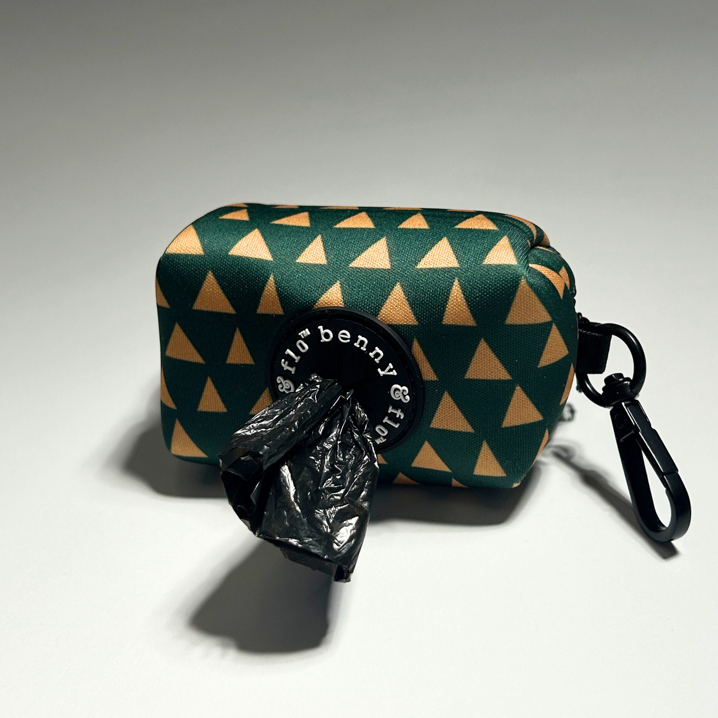 Green and yellow dog poop bag holder on white background