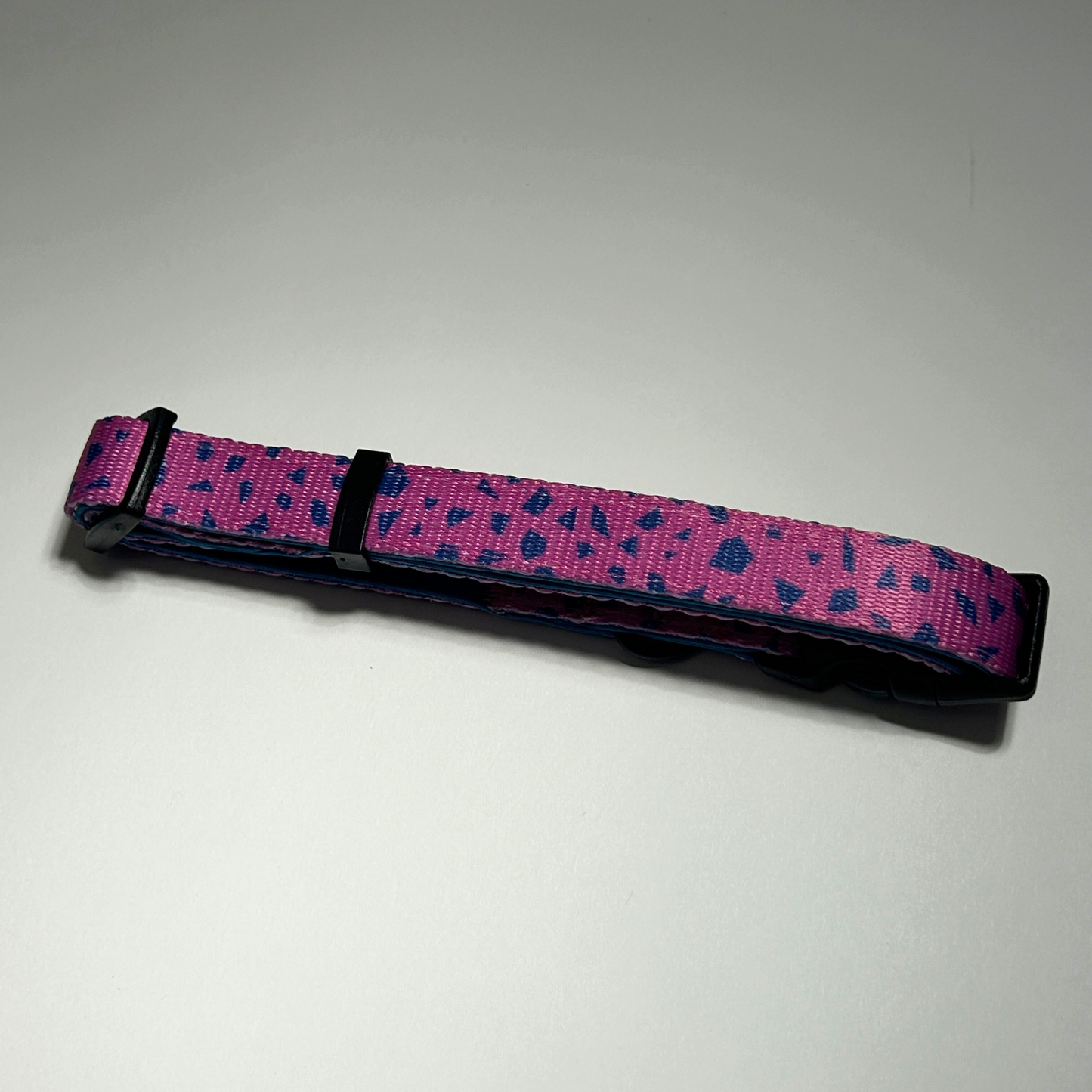 Purple and blue patterned dog collar on a white background