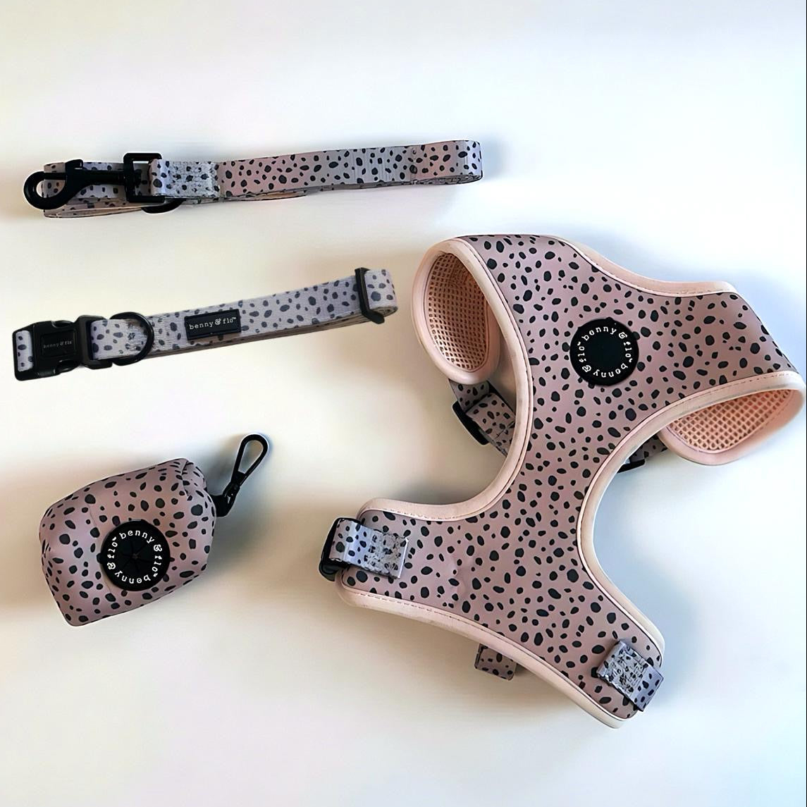 Dog harness, collar, and leash set with Dalmatian spot pattern on a light background