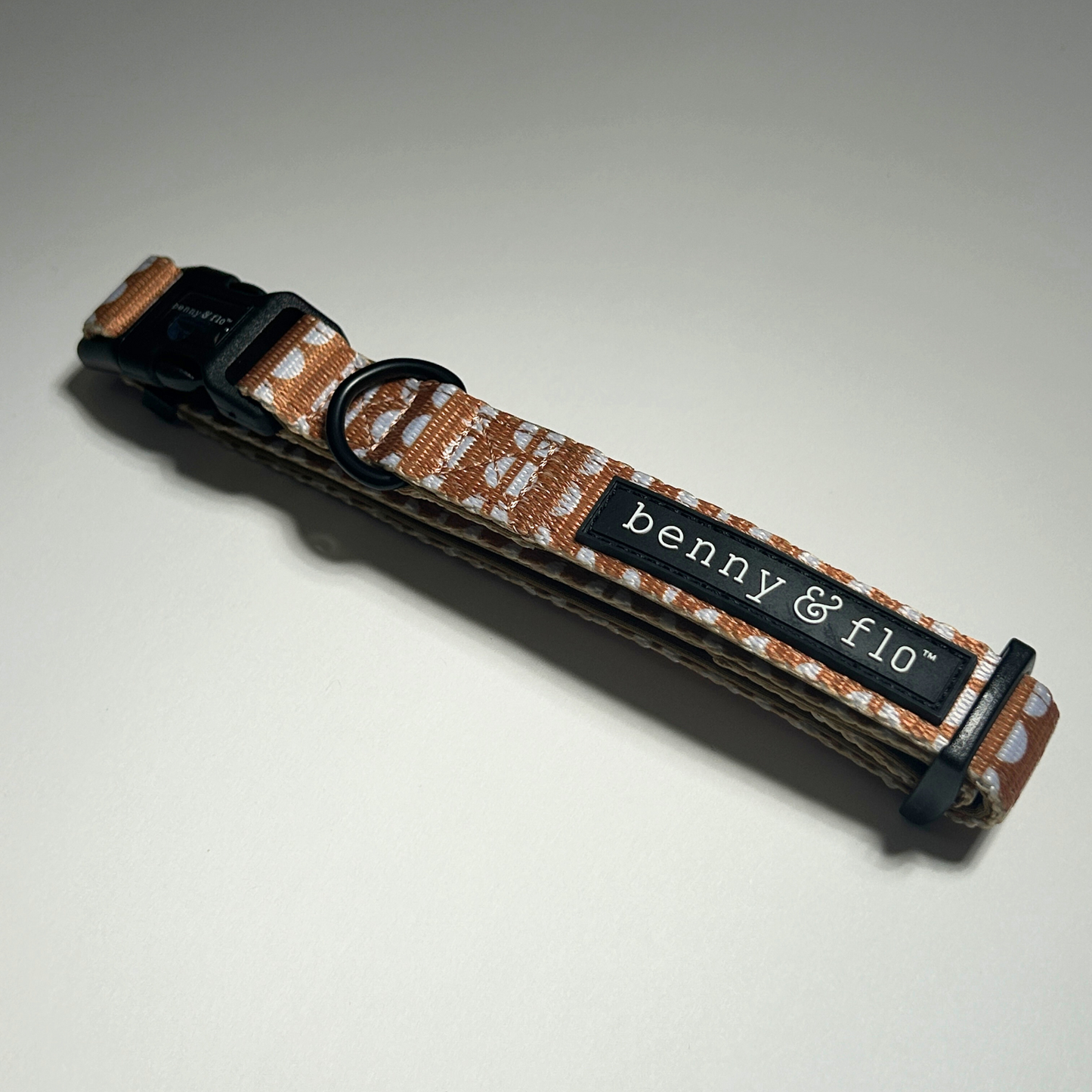 Brown gingerbread Dog collar with 'benny & flo' label on a white background