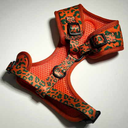 Orange dog harness with green pattern on a white background