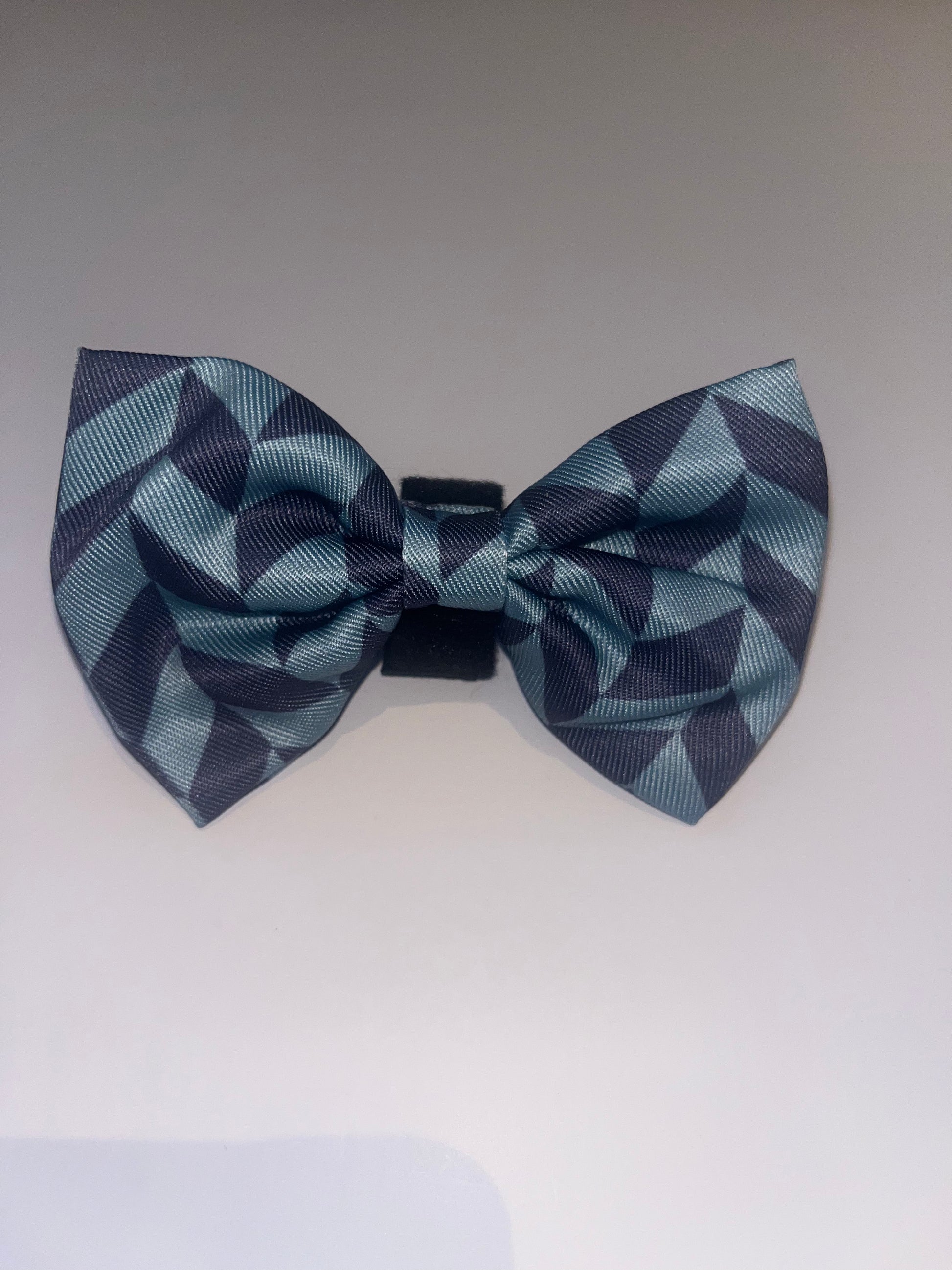 Blue geometric dog bow tie on a white background