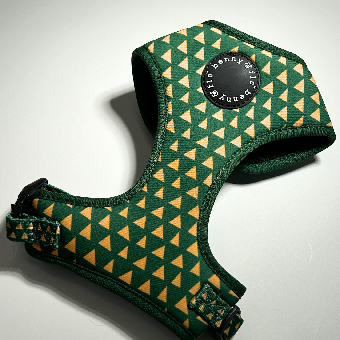 Green and yellow patterned dog harness with 'Benny & Flo' branding on a white background