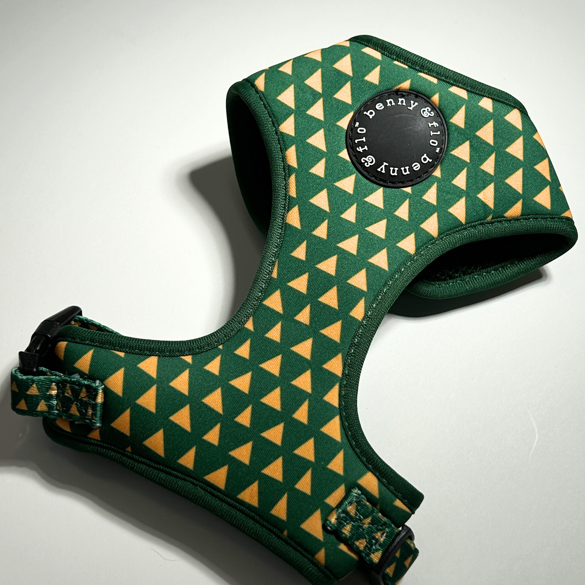 Green and yellow patterned dog harness with 'Benny & Flo' branding on a white background