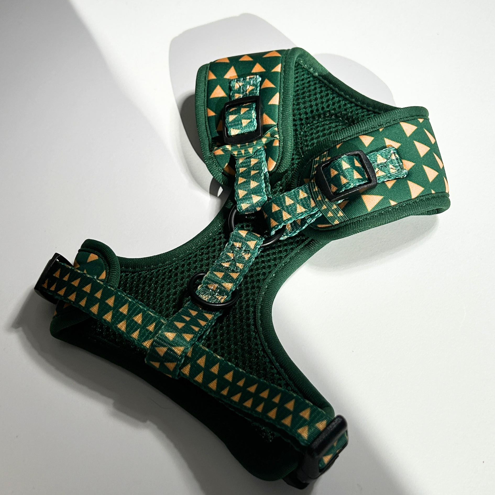 Green dog harness with cactus pattern on a white background