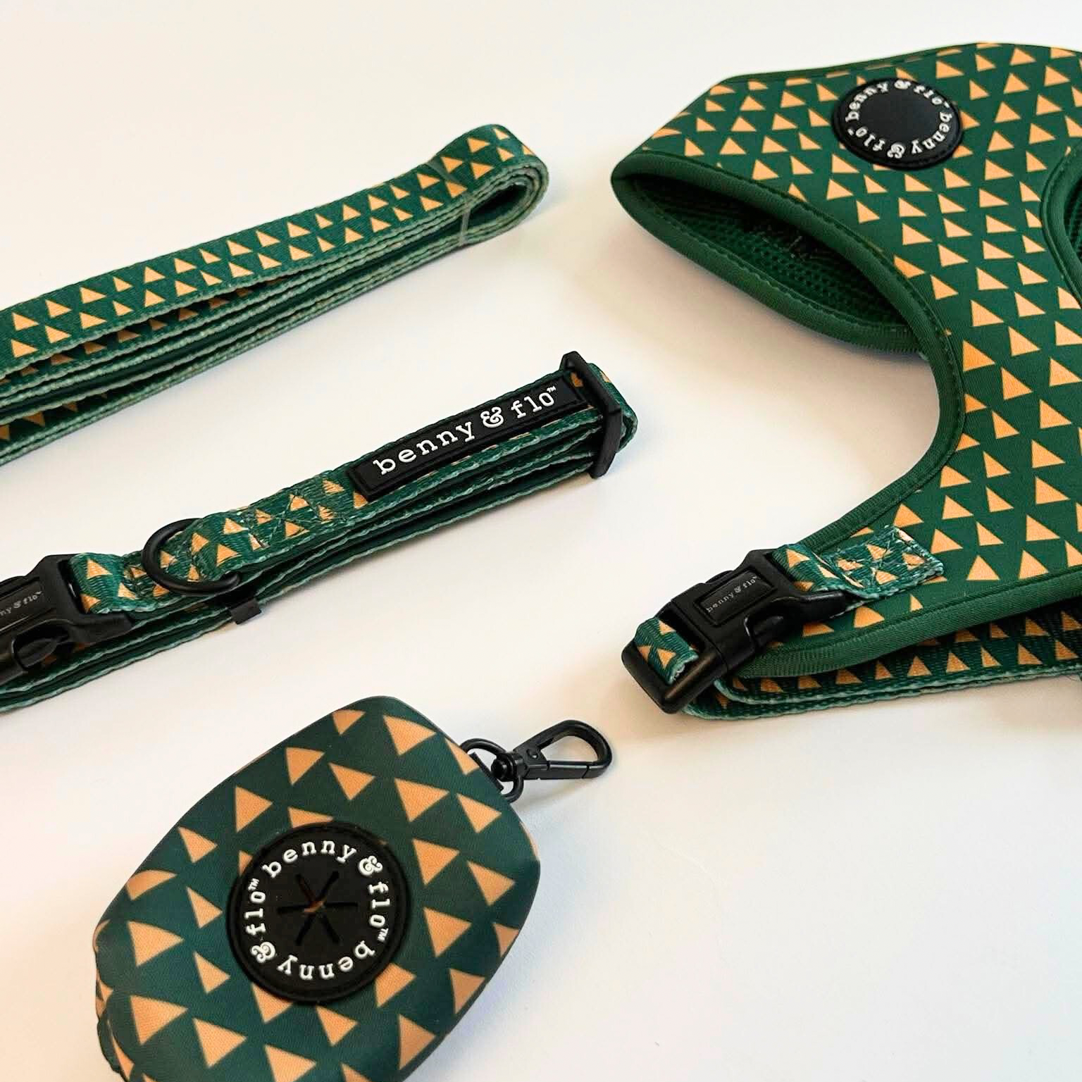 Green and yellow patterned dog collar, harness, and leash set on a white background
