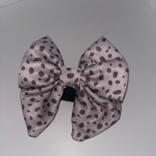 Pink and grey dog  bow on a white background